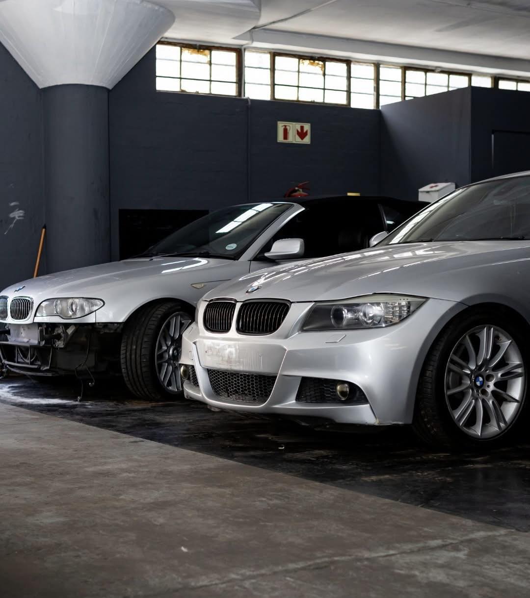 Silver BMW vehicles inside the AR Autoworks workshop in Salt River